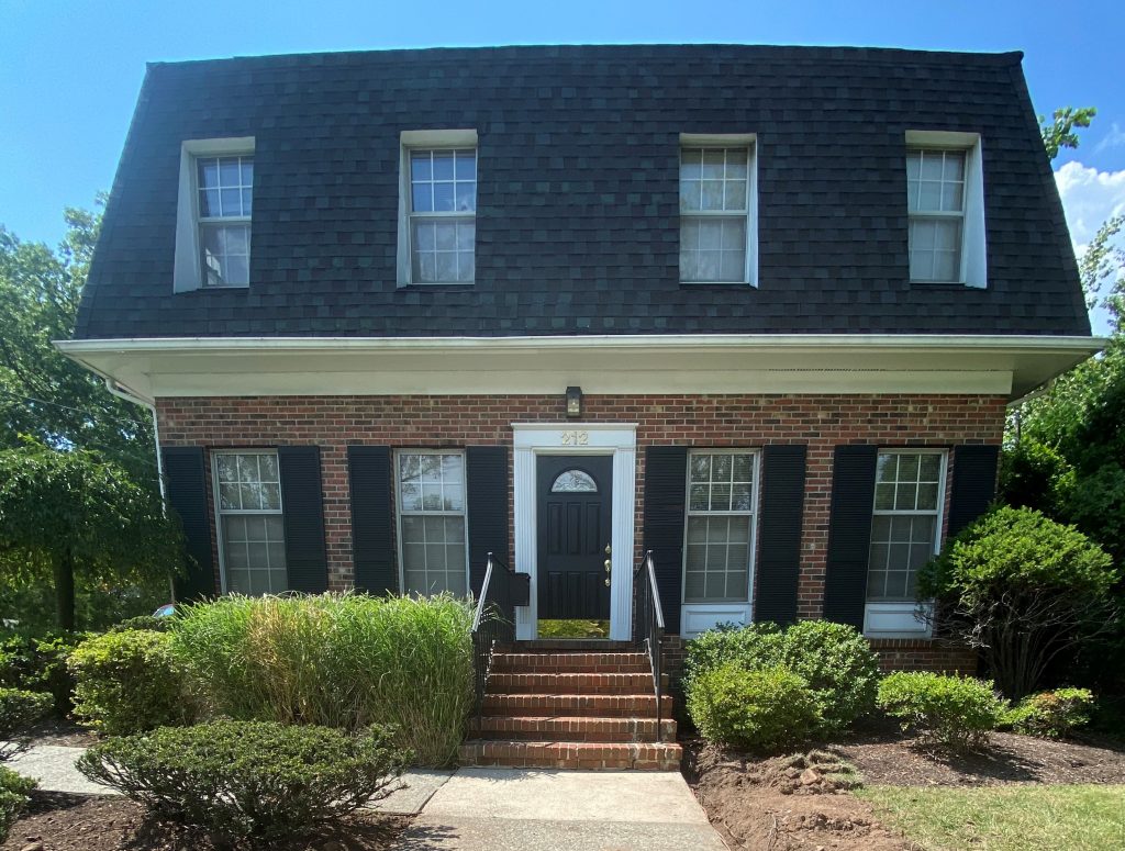 Fourte International Real Estate's Headquarters building in Essex County New Jersey with a sign on the front lawn advertising broker, attorney and property manager services